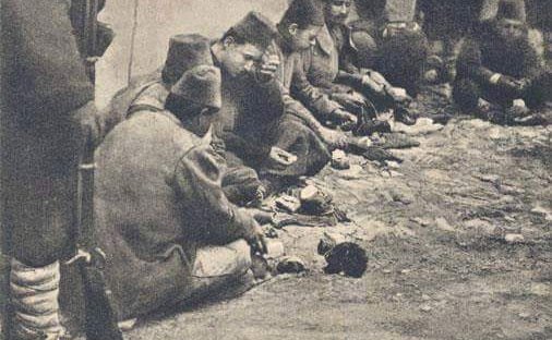 Turkish soldier sharing his food with a kitten, 1912