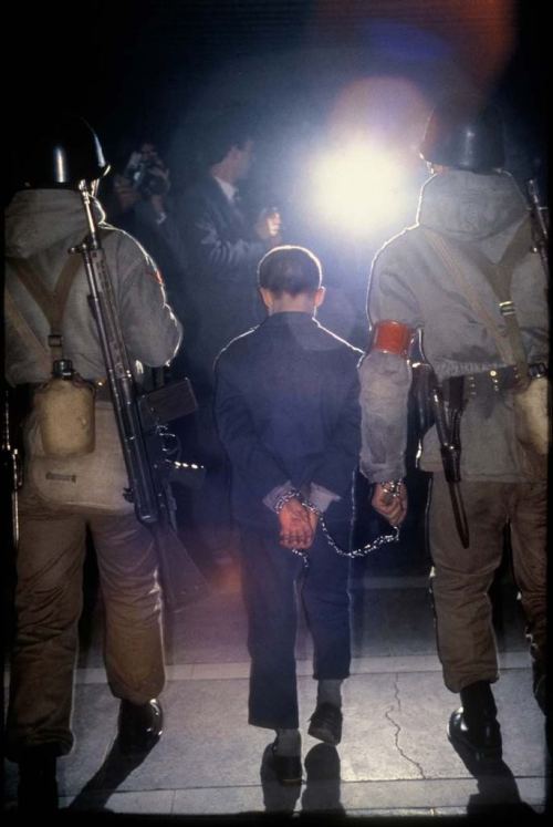 A twelve year old boy handcuffed by soldiers after 1980 military coup of Turkey