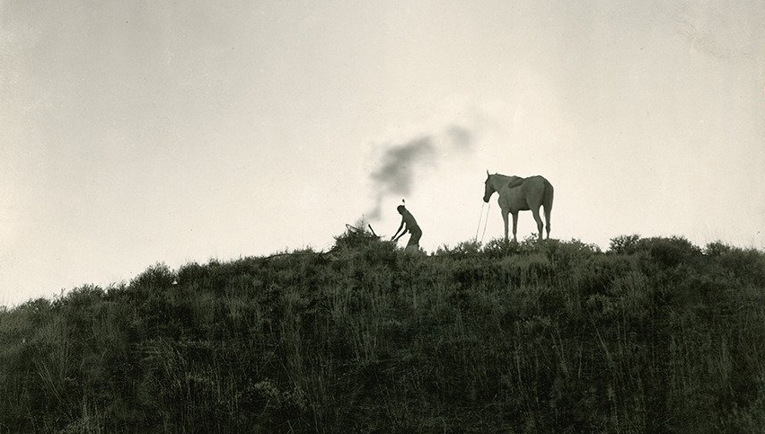 Native American sends smoke signals, Montana, 1909
